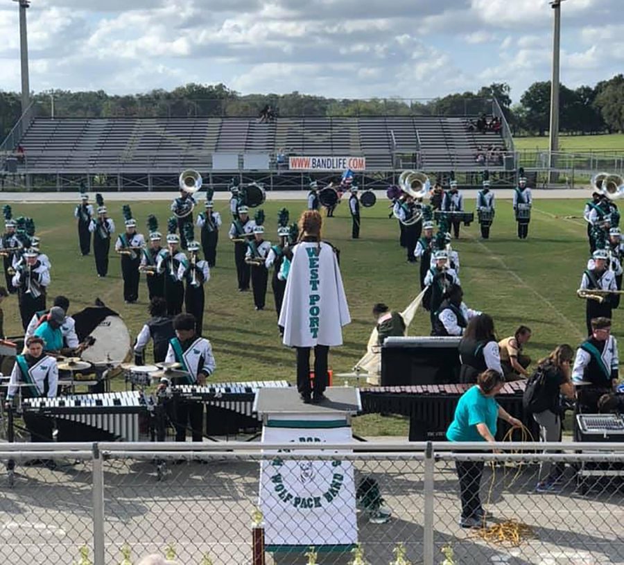 During the Fall, the West Port band prepares a marching show to compete in district competitions. On the podium is Dani ONeal, Senior Drum Major to the band. The title of the bands show was Fallen Soldier.  Photo credit: Debbie ONeal 