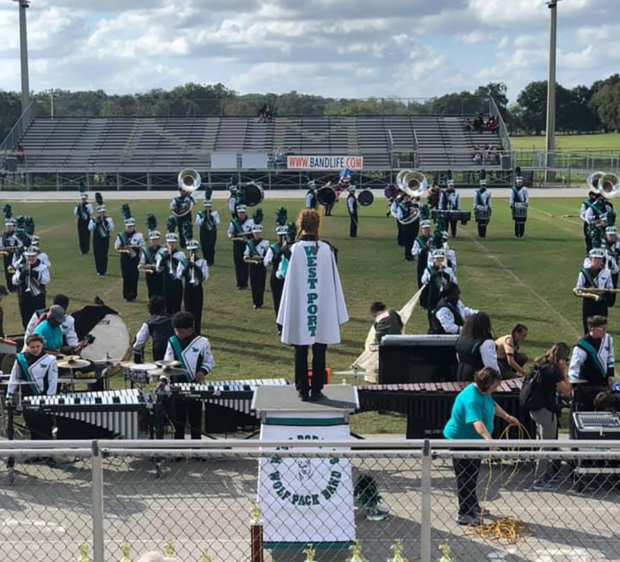 During the Fall, the West Port band prepares a marching show to compete in district competitions. On the podium is Dani O'Neal, Senior Drum Major to the band. The title of the band's show was "Fallen Soldier".  Photo credit: Debbie O'Neal 