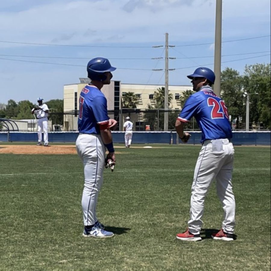 Assistant Coach Jon Koenigsfeld and Outfielder Garett Wallace talk during a game. The
Patriots would finish the year 37-15.