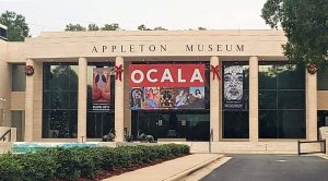 The entrance to the Appleton Museum with banners featuring the current art exhibits.