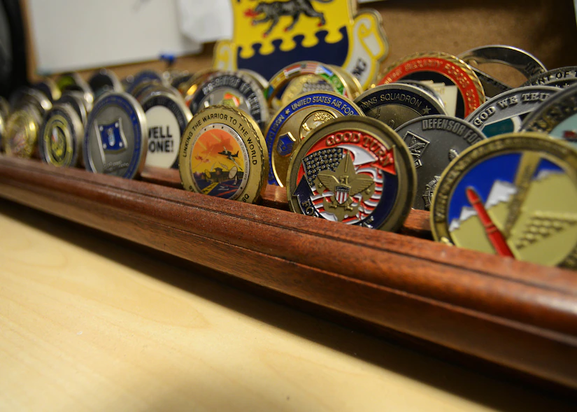 A stock image depicting military challenge coins with a variety of designs.