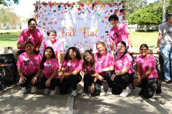 SAB team posing in front of Fall Fest banner. 