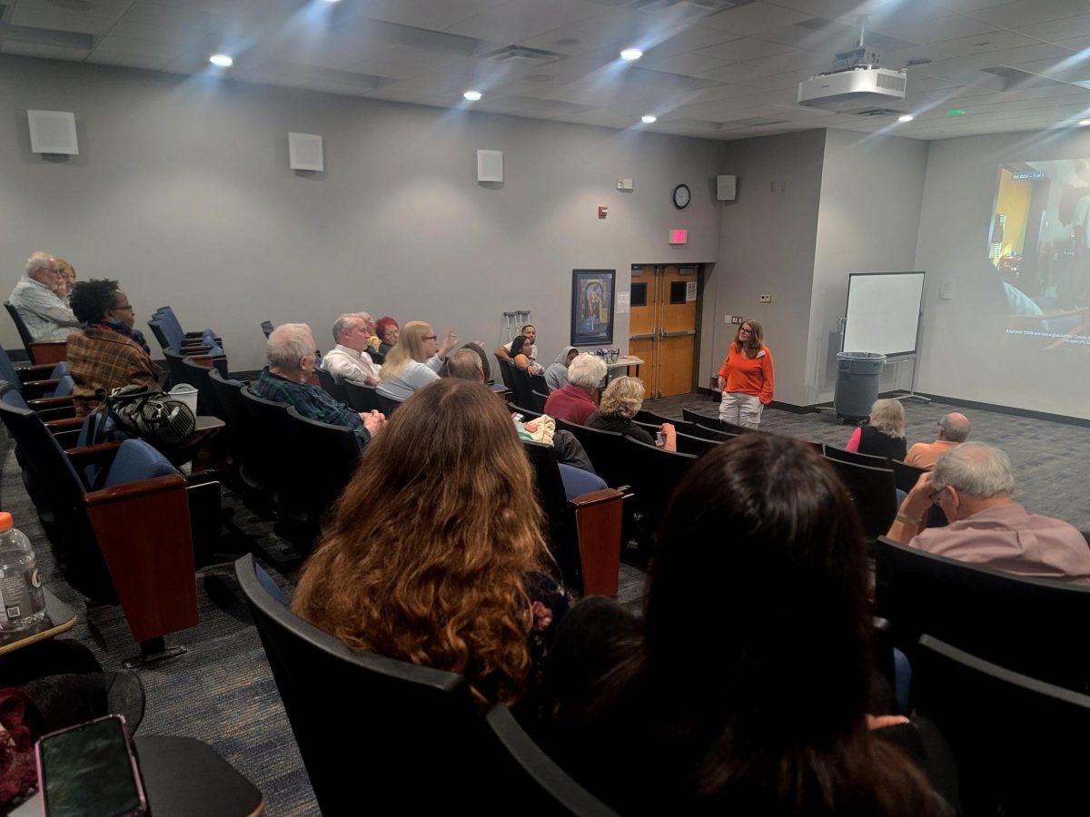 Wendy Adams, director of Ira Holmes International Film Series, giving a brief discussion on the topic of the film before the screening.