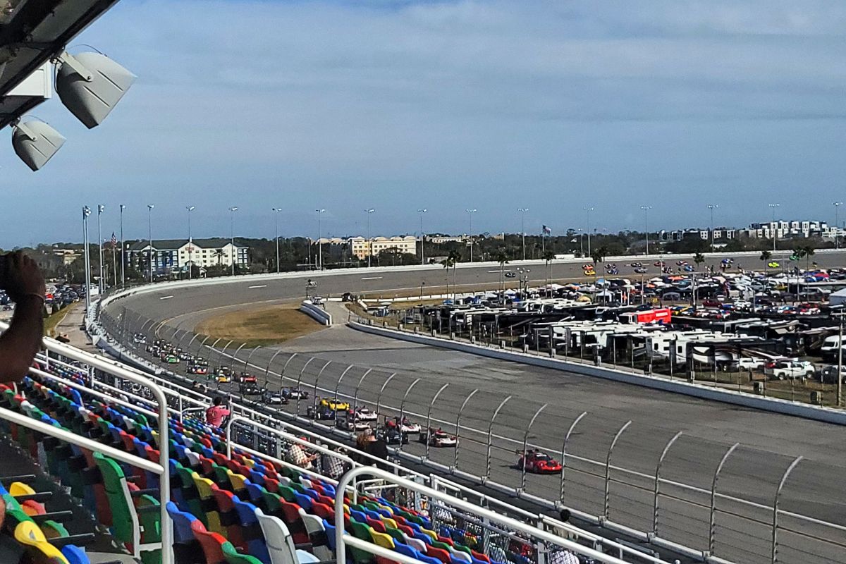 Fans pack the grandstands along the front stretch during the opening hours of the 2026 Rolex 24.